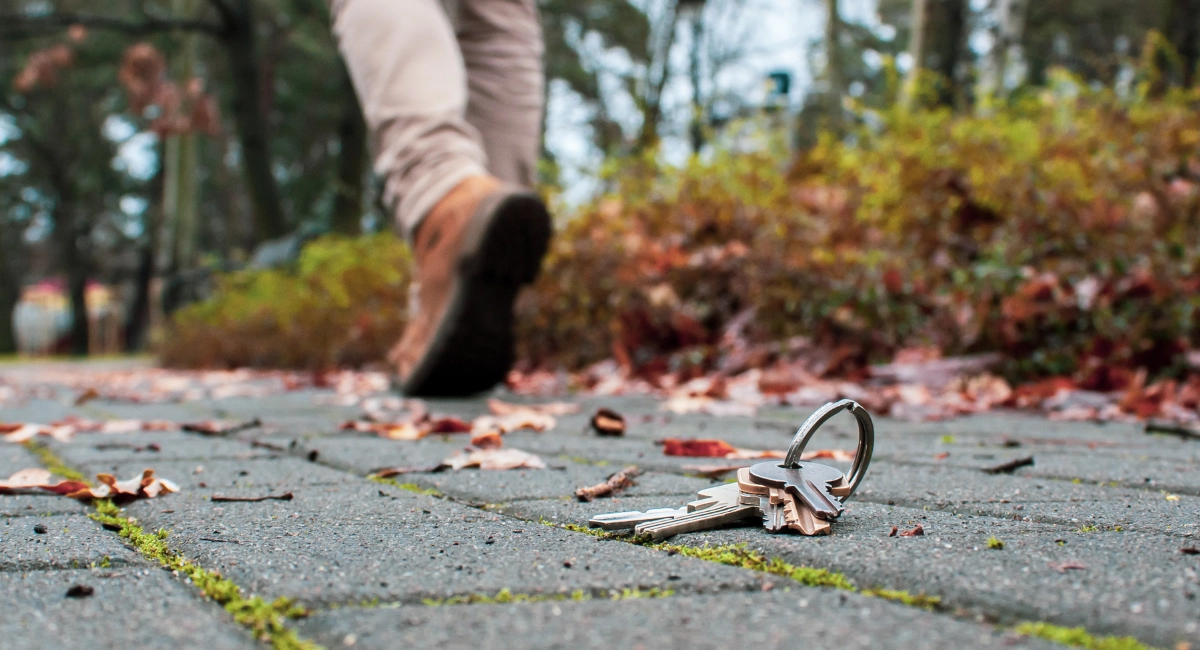 a person walking away from a set of keys left on the ground