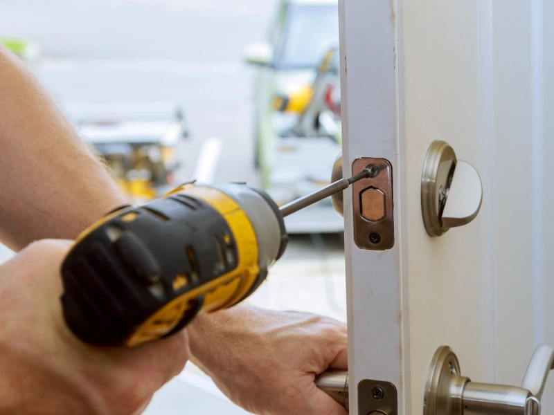 A locksmith installing a deadbolt