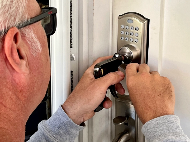 A locksmith unlocking a front door to a house