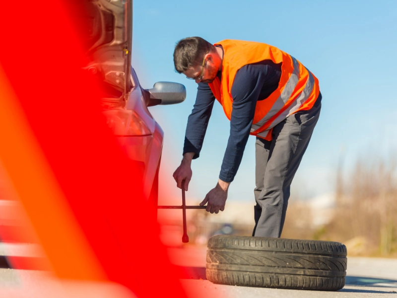 a mechanic working on a car tire