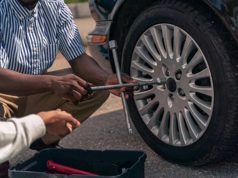 two mechanics working on a car